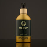 Olew Hold Spray - Curl Keeper, giving natural hold and shine. Vegan haircare which is SLS and Paraben Free, in a gold and dark green bottle with a spray mist pump on top. The image is on a dark grey background