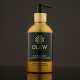 Olew, Intense Deep Conditioning Hair Mask, naturally hydrating vegan haircare which is SLS and Paraben Free comes in a gold and dark green bottle with a push pump on top. The image is on a dark grey background