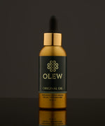 Olew Original Hair Oil, naturally moisturising vegan haircare which is SLS and Paraben Free, in a gold and dark green bottle with a pipette on top. The image is on a dark grey background