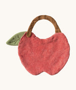 The reverse side of the Oli & Carol Peppa the apple baby bib available at Babipur. A organic cotton bib in a shape of a red apple cut in half. Features a popper fastener for size adjustment. 