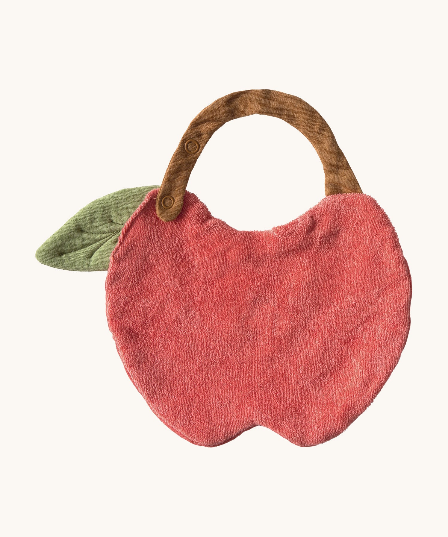 The reverse side of the Oli & Carol Peppa the apple baby bib available at Babipur. A organic cotton bib in a shape of a red apple cut in half. Features a popper fastener for size adjustment. 