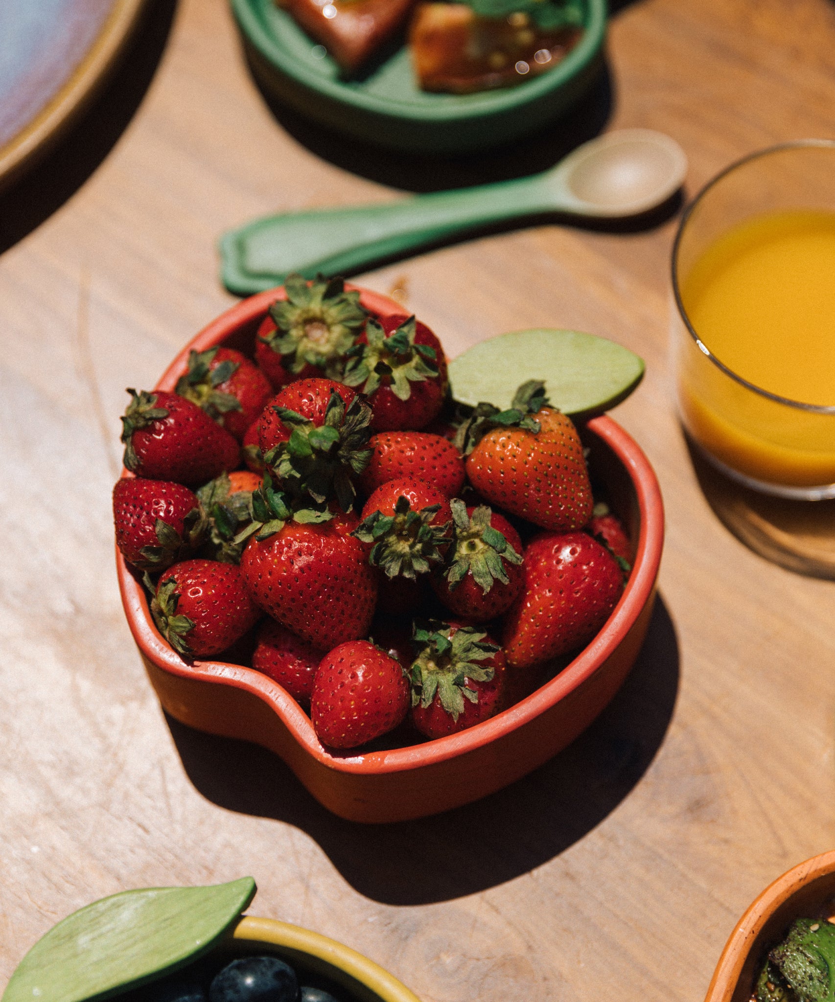 Apple Kids and Baby Wooden bowl filled with strawberries, by Oli and Carol, for sale now at Babipur.