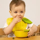 A child eating fruit from the Oli & Carol Lou the lemon wooden bowl set available at Babipur. 