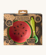 A close up of the cardboard packing holding the Oli & Carol Wally the watermelon wooden bowl and spoon set available at Babipur. 