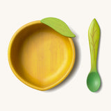 Oli & Carol Lou the lemon wooden bowl and spoon set available at Babipur. Features a decorative green leaf on the bowl.