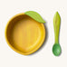 Oli & Carol Lou the lemon wooden bowl and spoon set available at Babipur. Features a decorative green leaf on the bowl.