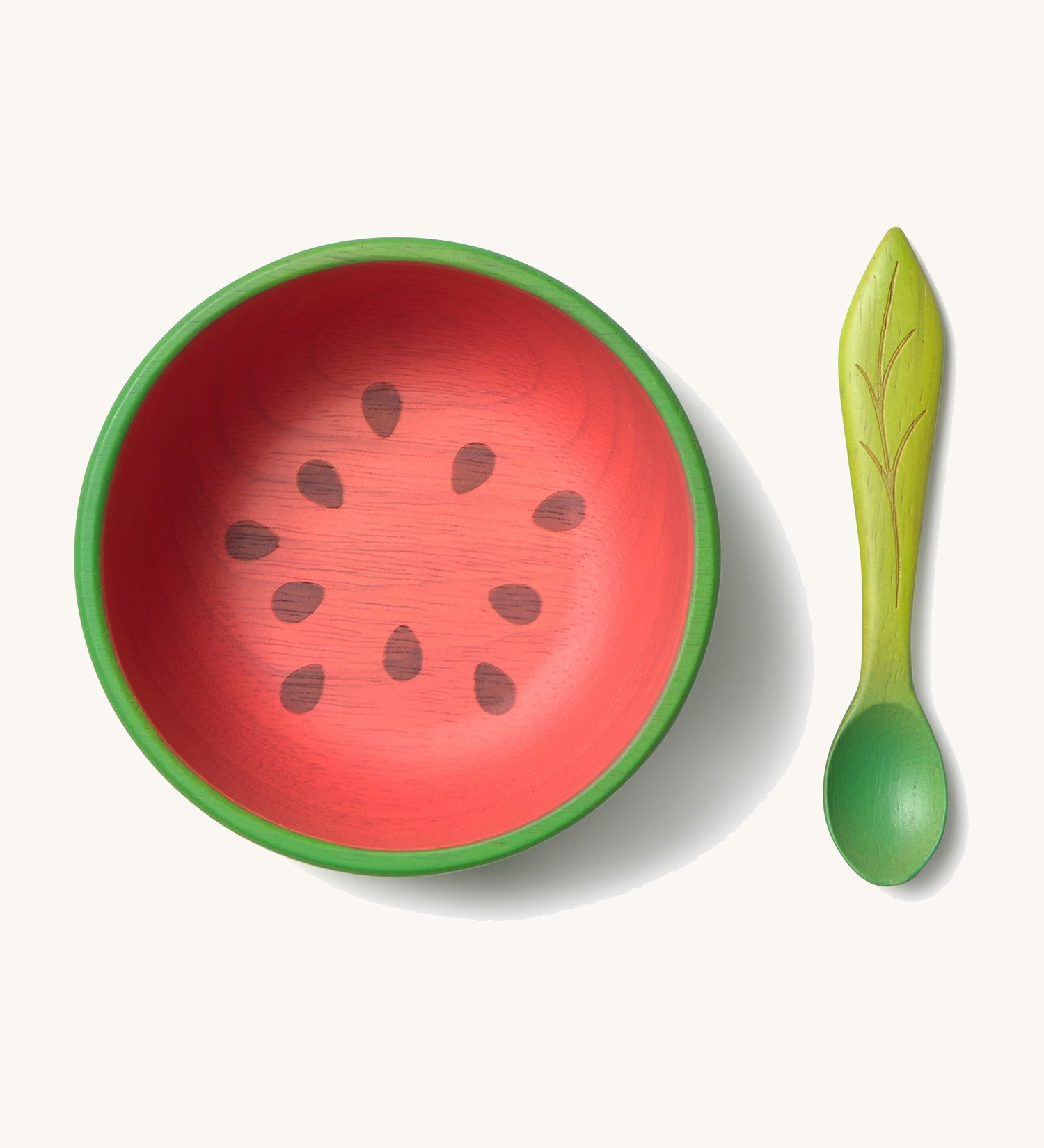 Oli & Carol Wally the watermelon wooden bowl and spoon set available at Babipur.  The bowl is in a shape of a watermelon cut in half