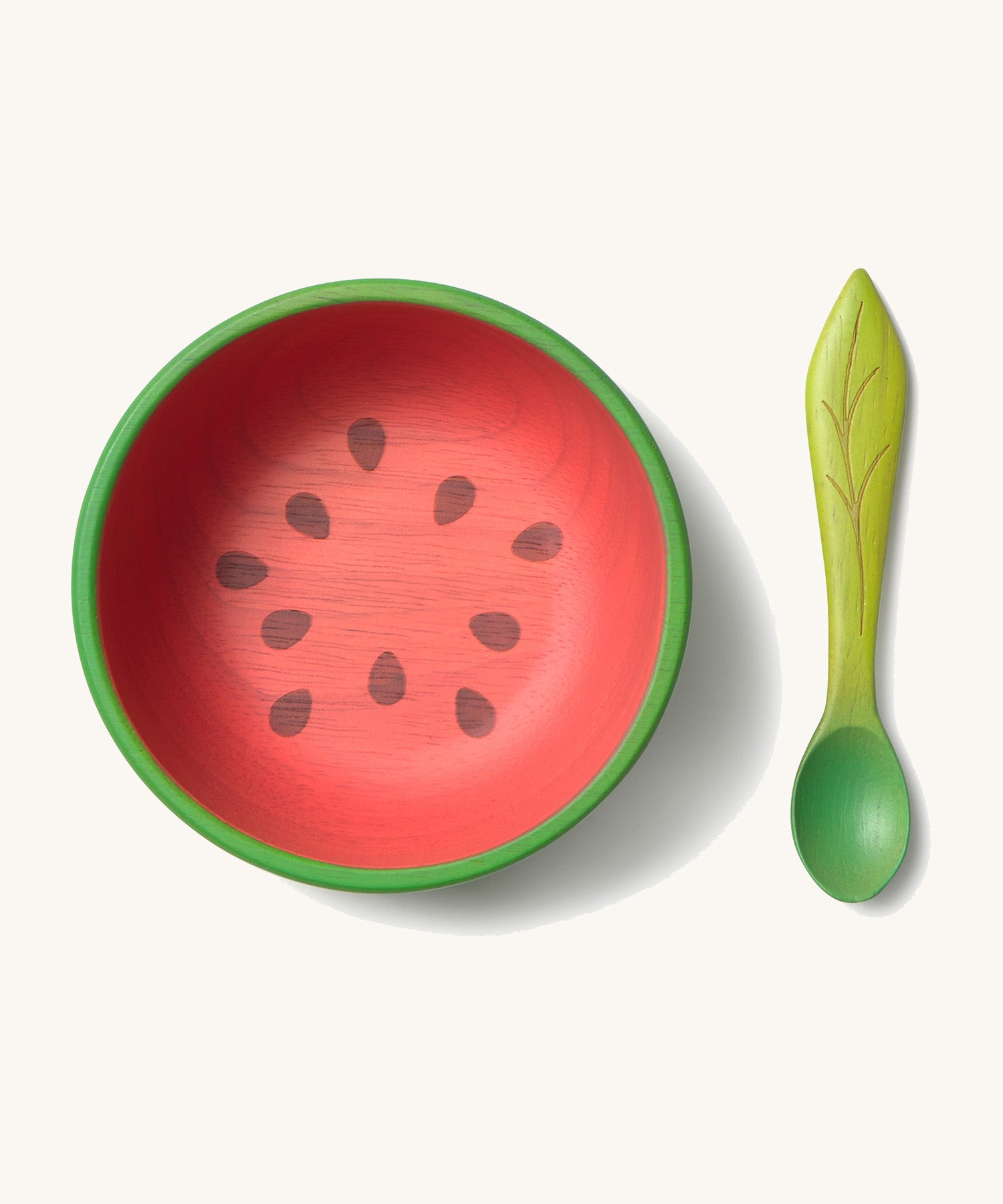 Oli & Carol Wally the watermelon wooden bowl and spoon set available at Babipur.  The bowl is in a shape of a watermelon cut in half