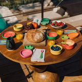A alfresco lunch including the Oli & Caro wooden baby weaning spoons and bowl sets available at Babipur.