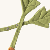 A close up of the  Oli & Carol Cathy the carrot baby bib available at Babipur showing the popper fastener for size adjustment. 