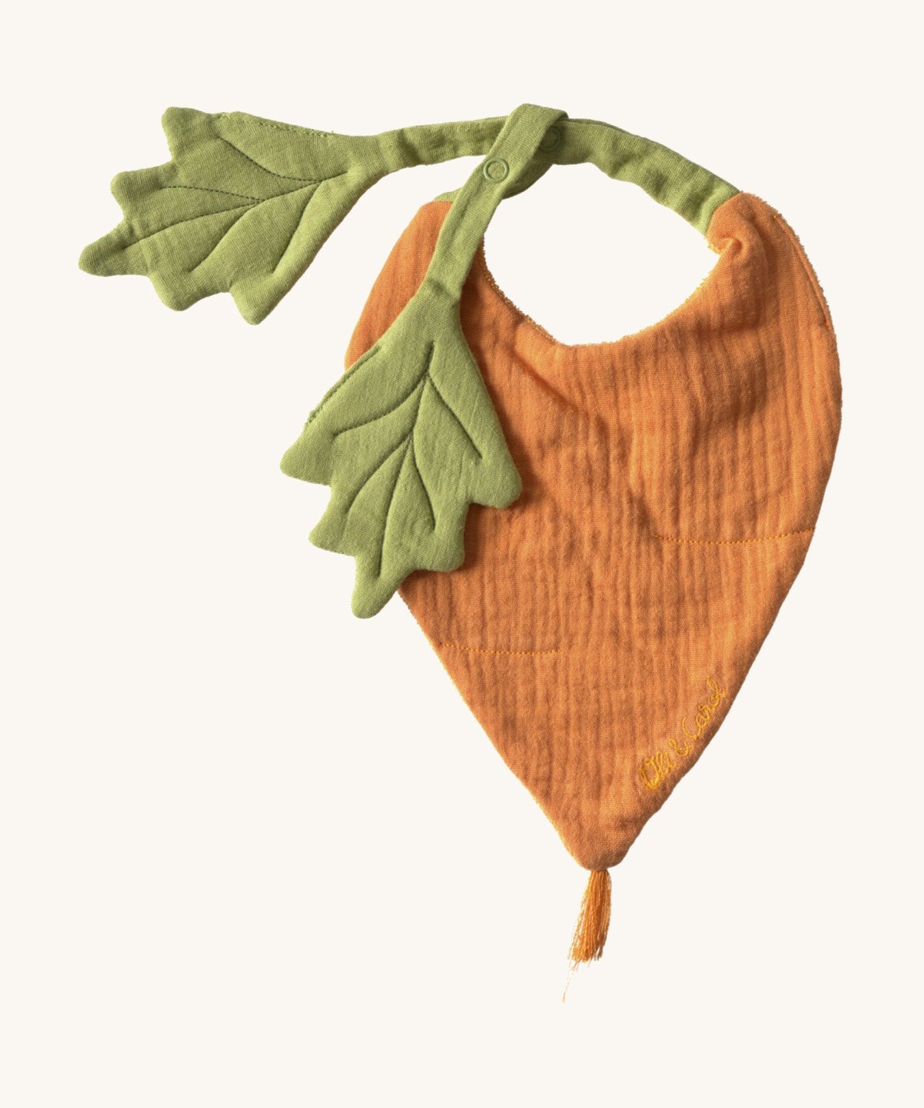 Oli & Carol Cathy the carrot baby bib available at Babipur. A organic cotton bib in a shape of a orange carrot  Features a popper fastener. 