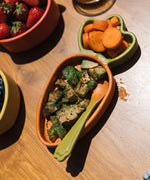 A close up of the Oli & Carol Cathy the carrot wooden plate filled with food in both dividers available at Babipur. 