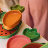 Oli & Carol Cathy the carrot wooden plate stacked on the kale plate available at Babipur. 