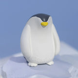 Oli & Carol Penguin Bath Toy Set on a blue background