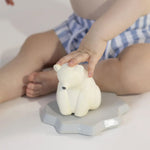 A child playing with the Oli & Carol Polar Bear Bath Toy Set with the Polar Bear stood on its floating base
