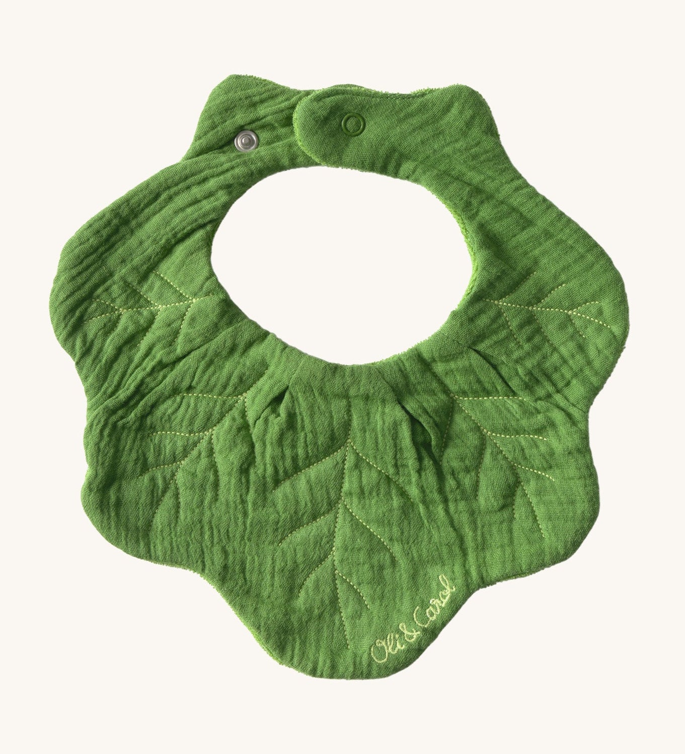 Oli & Carol Kendal the kale baby bib available at Babipur. A organic cotton bib in a shape of green kale. Features a popper fastener. 