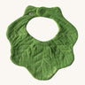 Oli & Carol Kendal the kale baby bib available at Babipur. A organic cotton bib in a shape of green kale. Features a popper fastener. 