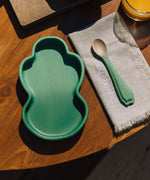 Oli & Carol wooden kale plate and spoon set on a table available at Babipur.