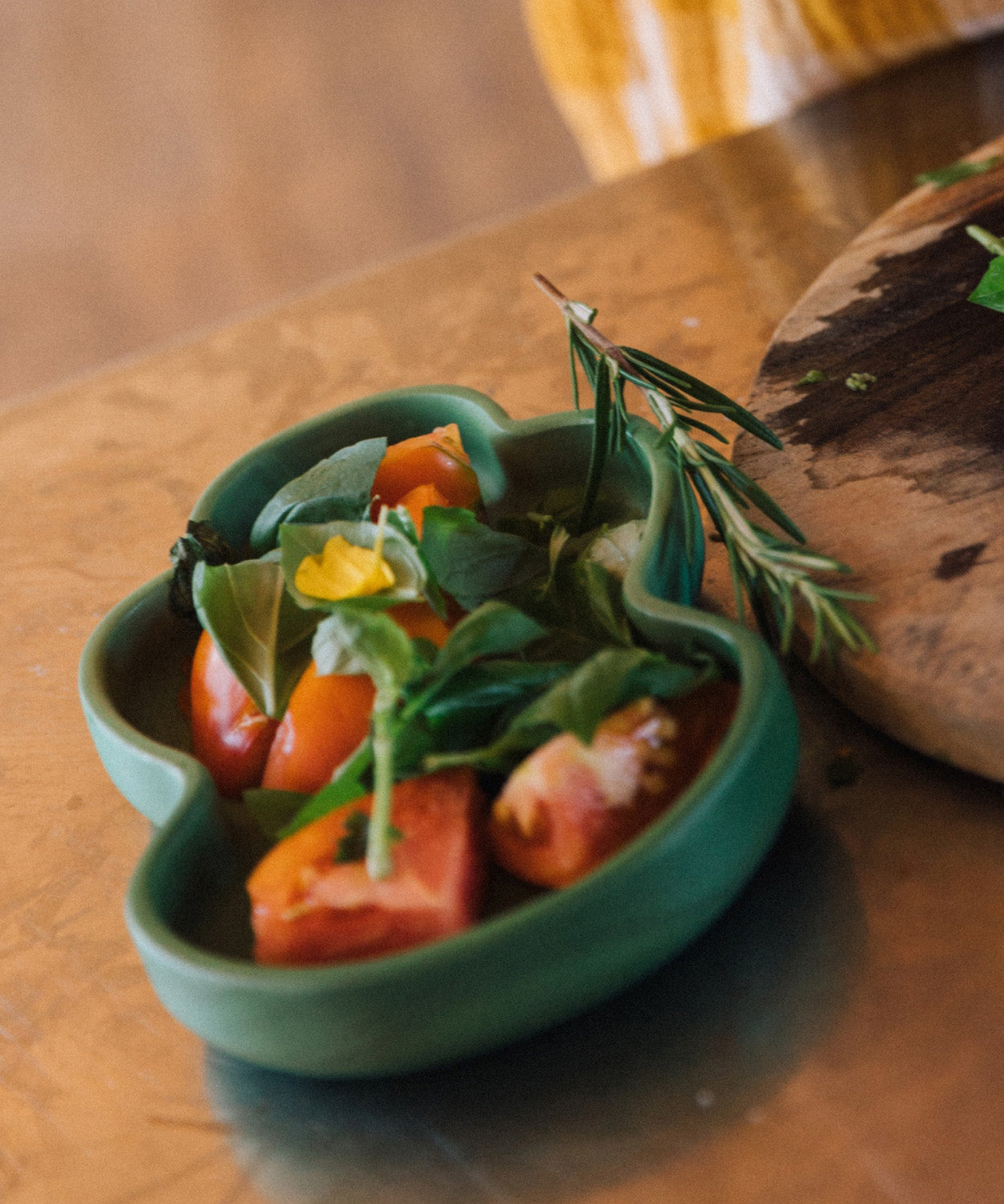 A close up of food on the Oli & Carol Kendall the Kale wooden plate and spoon set available at Babipur.