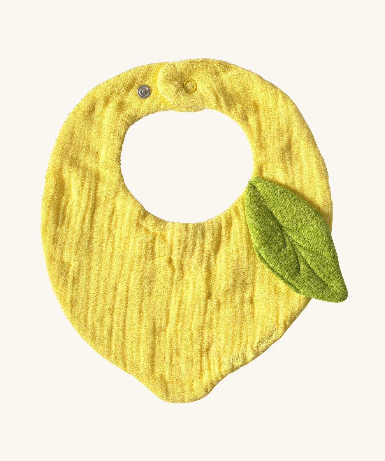 Oli & Carol Lou the lemon baby bib available at Babipur. A organic cotton bib in a shape of a yellow lemon. Features a popper fastener. 
