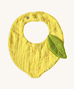 Oli & Carol Lou the lemon baby bib available at Babipur. A organic cotton bib in a shape of a yellow lemon. Features a popper fastener. 