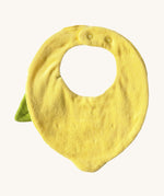 The reverse side of the Oli & Carol Lou the lemon baby bib available at Babipur. A organic cotton bib in a shape of a yellow lemon. Features a popper fastener for size adjustment. 