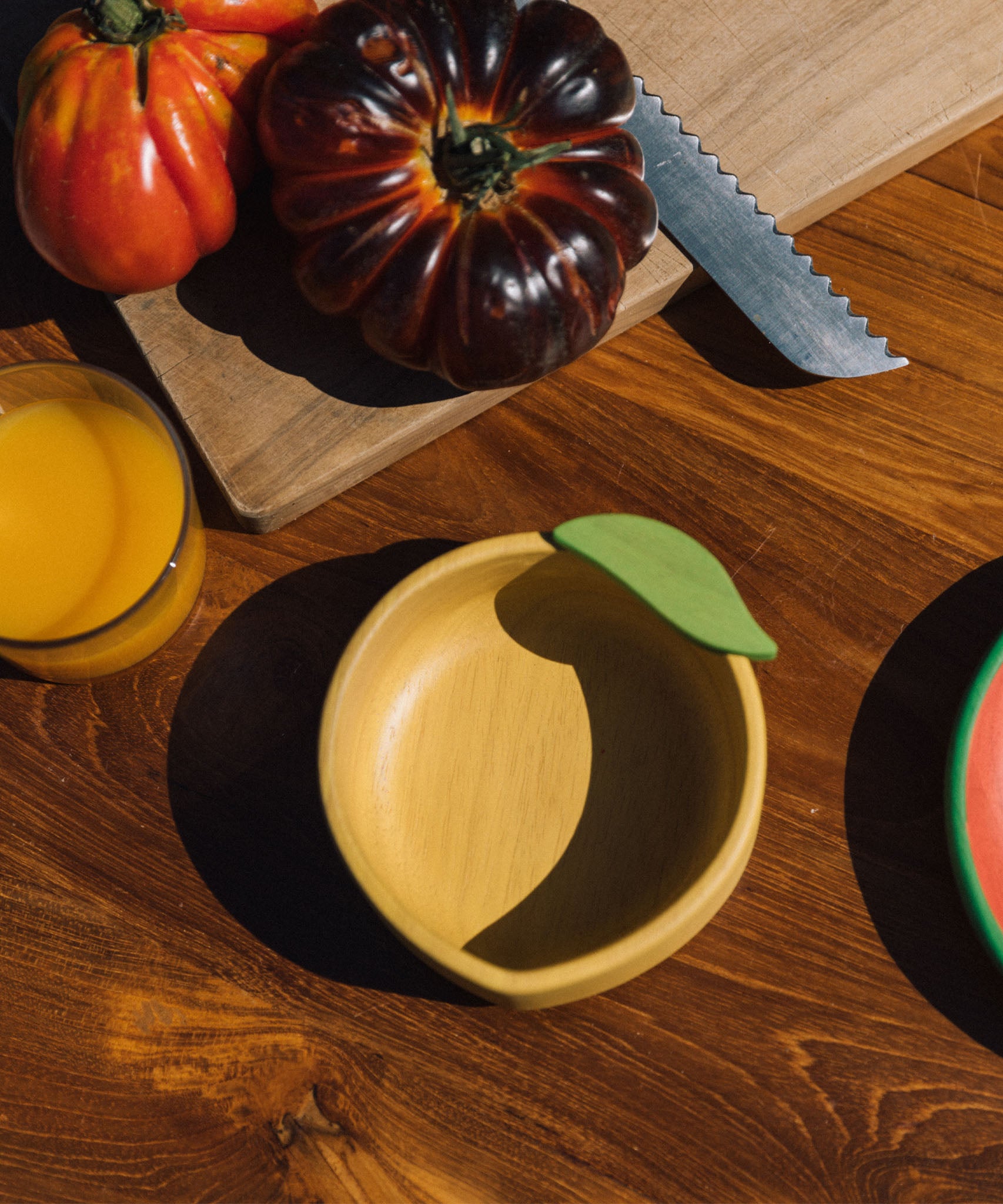 A close up of the Oli & Carol Lou the lemon wooden bowl on a table available at Babipur 
