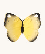 The Oli & Carol Natural Rubber Teether - Katia The Butterfly, showing a yellow natural rubber teether on a cream background