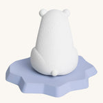 The back of the Oli & Carol Polar Bear Bath Toy showing a little polar bear tail and the texture of the natural rubber. On a cream background