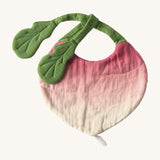 Oli & Carol Ramona the radish baby bib available at Babipur. A organic cotton bib in a shape of a radish. Features a popper fastener. 