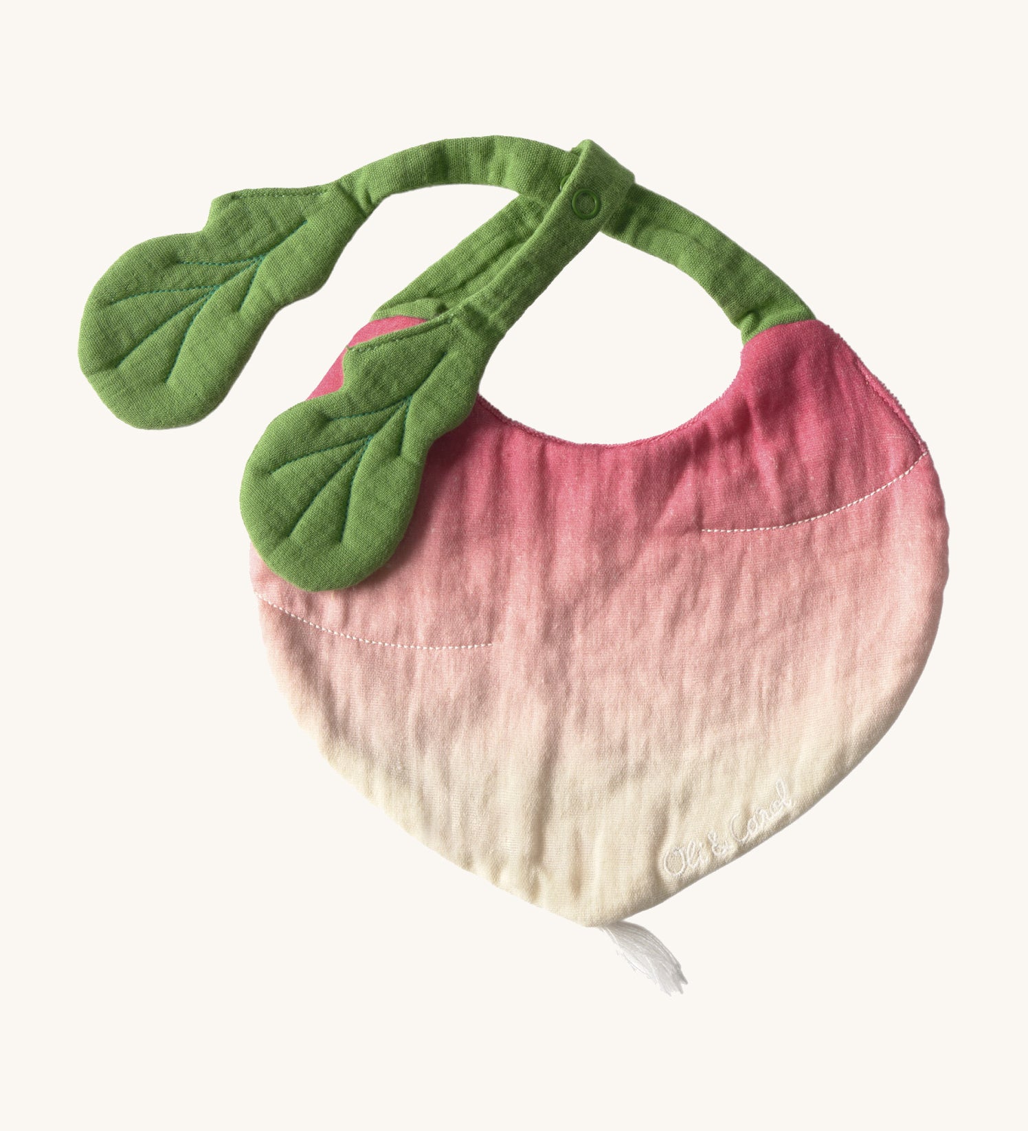 Oli & Carol Ramona the radish baby bib available at Babipur. A organic cotton bib in a shape of a radish. Features a popper fastener. 