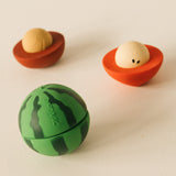 A image showing the watermelon and one half of the cherry and apple Oli & Carol stacking toy rattle balls available at Babipur.