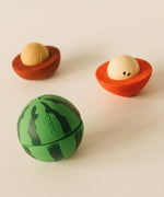 A image showing the watermelon and one half of the cherry and apple Oli & Carol stacking toy rattle balls available at Babipur.