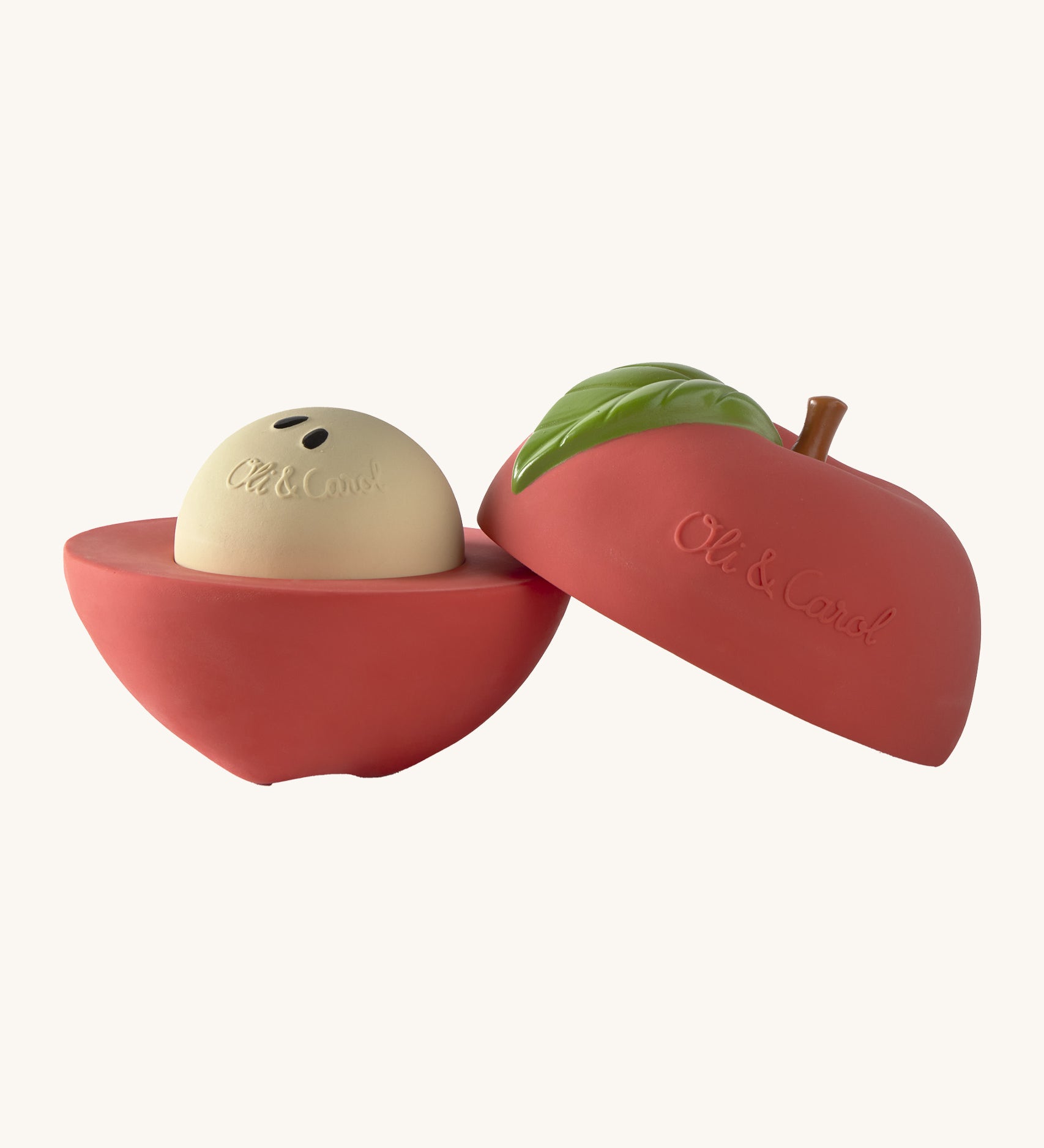 A opened Oli & Carol red apple stacking toy rattle ball available at Babipur. Showing the 2 halves with the core. 