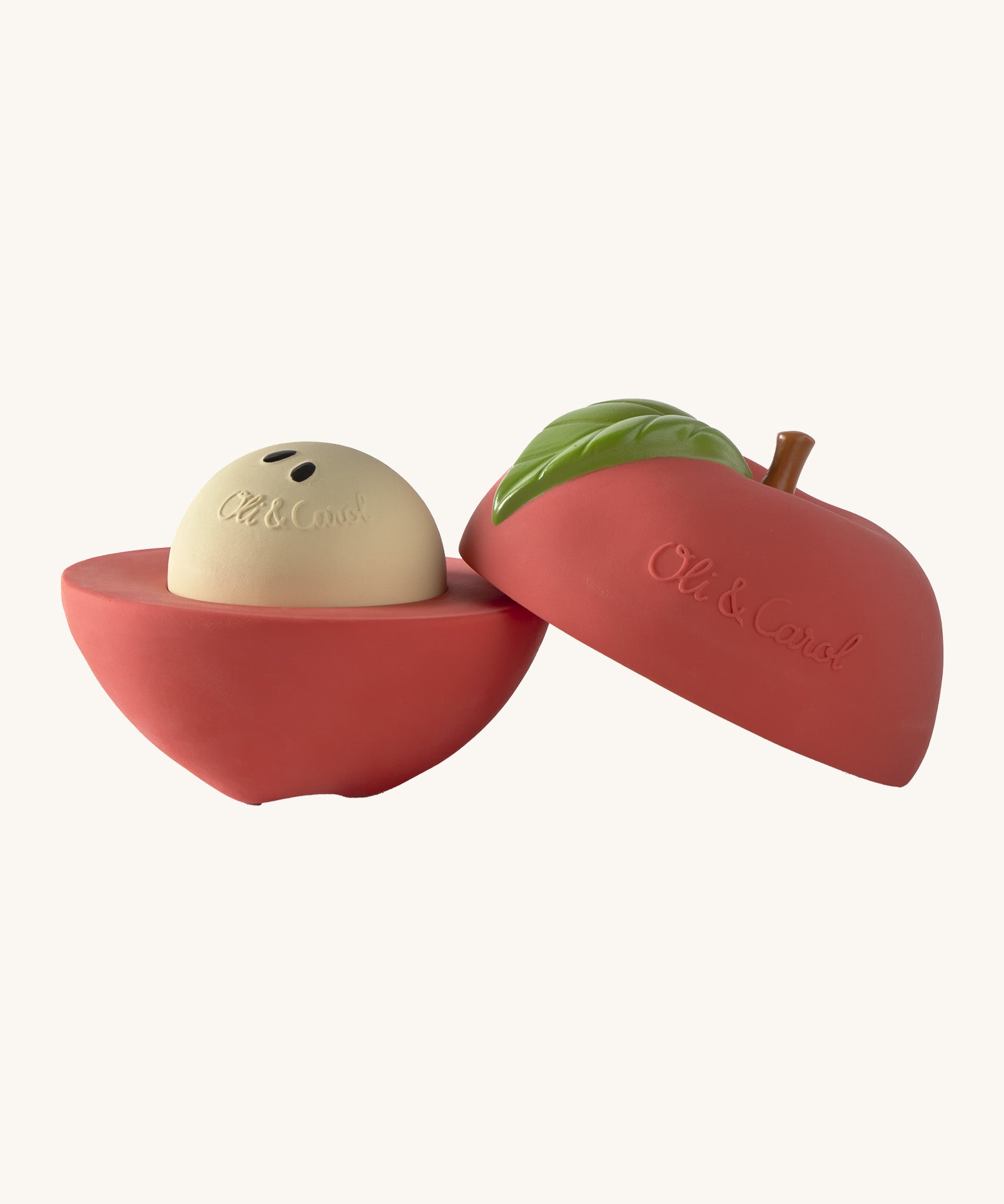 A opened Oli & Carol red apple stacking toy rattle ball available at Babipur. Showing the 2 halves with the core. 