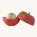 A opened Oli & Carol red apple stacking toy rattle ball available at Babipur. Showing the 2 halves with the core. 