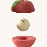 Oli & Carol red apple stacking toy rattle ball available at Babipur. Showing the 2 halves with the core. 