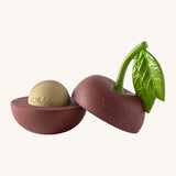 A opened Oli & Carol cherry stacking toy rattle ball available at Babipur. Showing the 2 halves with the core. 