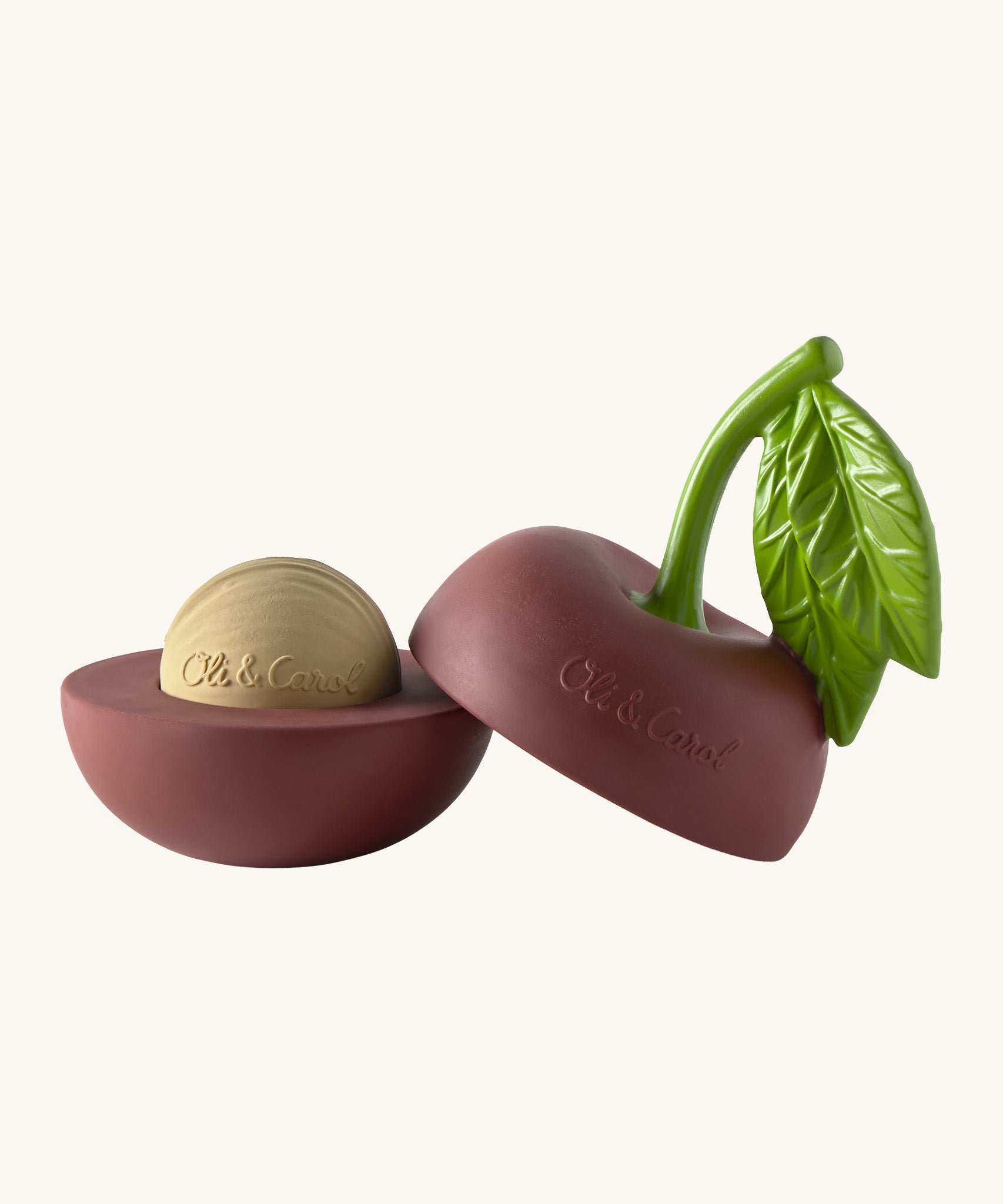 A opened Oli & Carol cherry stacking toy rattle ball available at Babipur. Showing the 2 halves with the core. 