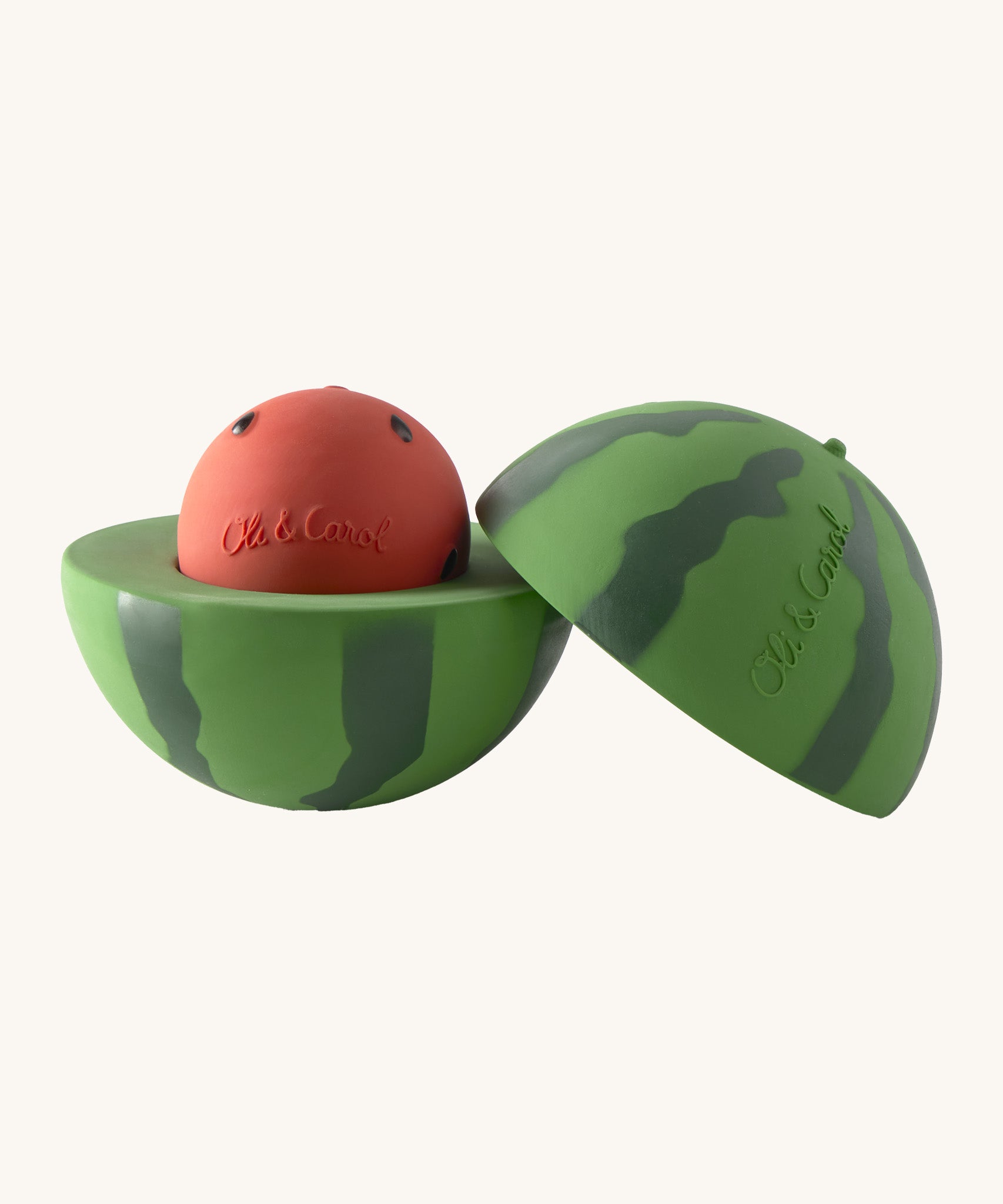 A opened Oli & Carol watermelon stacking toy rattle ball available at Babipur. Showing the 2 halves with the core. 