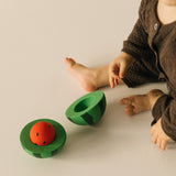 A child with a open watermelon Oli & Carol toy rattle available at Babipur