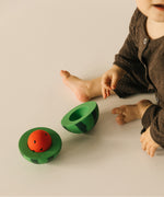 A child with a open watermelon Oli & Carol toy rattle available at Babipur