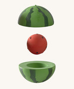 Oli & Carol watermelon stacking toy rattle ball available at Babipur. Showing the 2 halves with the core. 