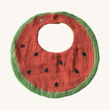 Oli & Carol Wally the watermelon baby bib available at Babipur. A organic cotton bib in a shape of a watermelon cut in half. Features a popper fastener. 