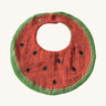 Oli & Carol Wally the watermelon baby bib available at Babipur. A organic cotton bib in a shape of a watermelon cut in half. Features a popper fastener. 