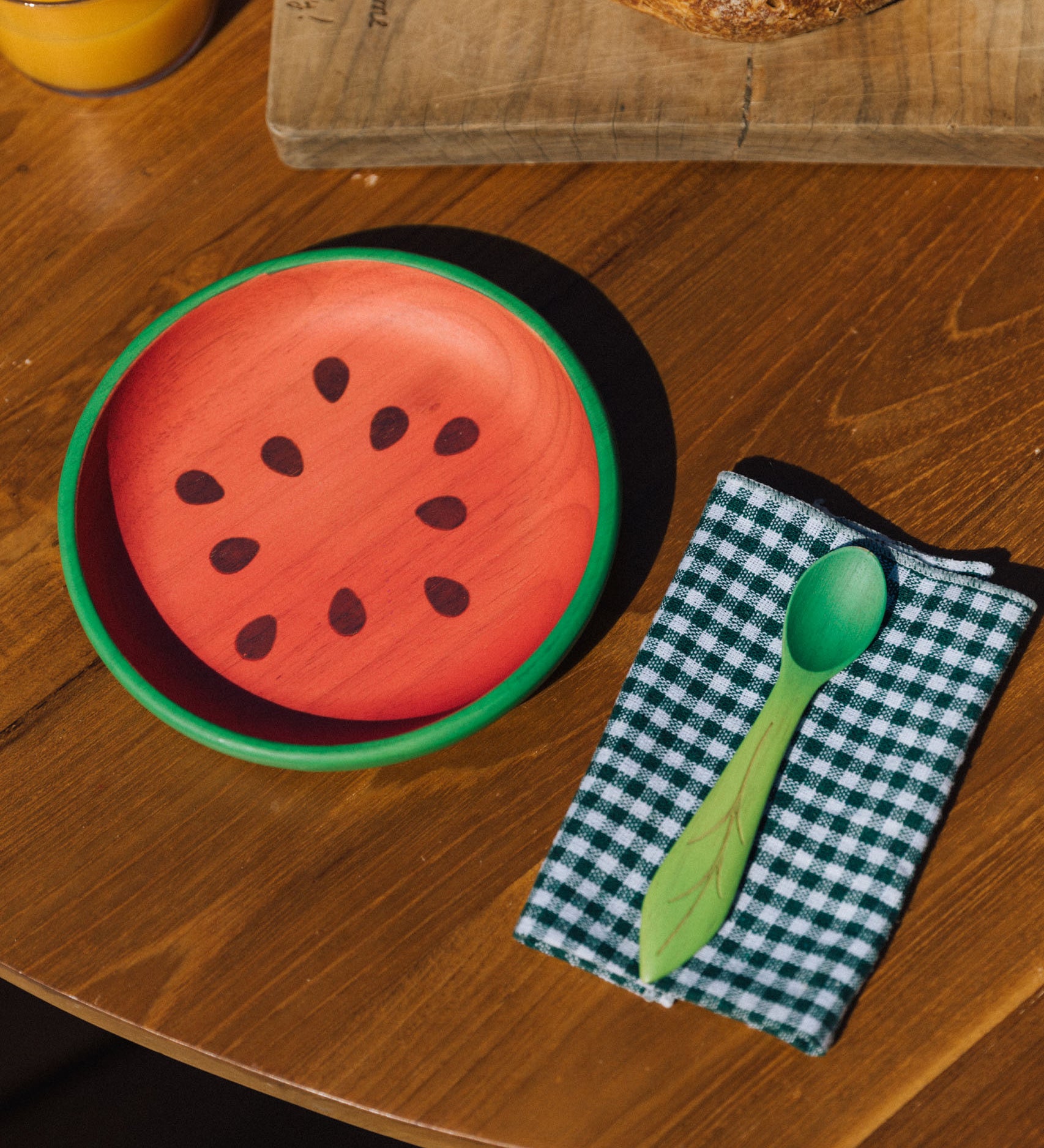 Oli & Carol Wally the watermelon wooden plate and spoon on a table set available at Babipur. 