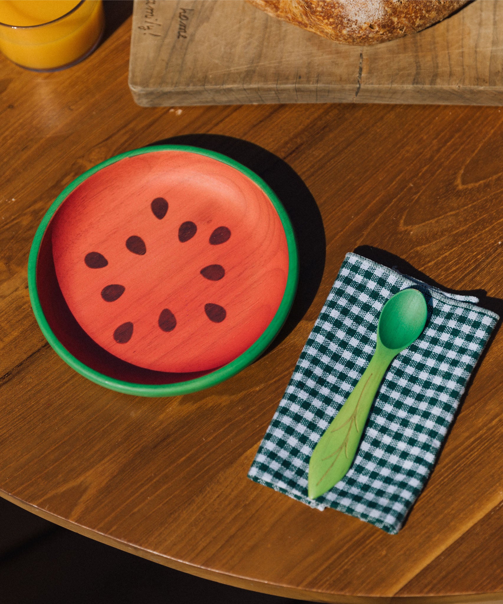 Oli & Carol Wally the watermelon wooden plate and spoon on a table set available at Babipur. 