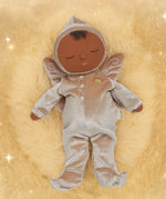 Olli Ella Ada fairy dozy dinkum doll lying on a soft brown surface. 