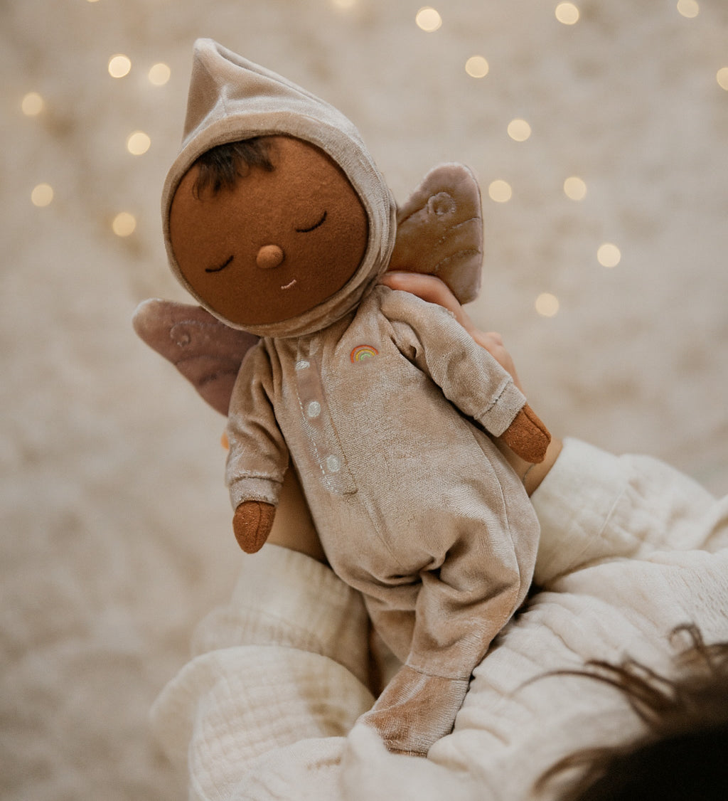 A child holding the pink Olli Ella Ada fairy dozy dinkum doll 