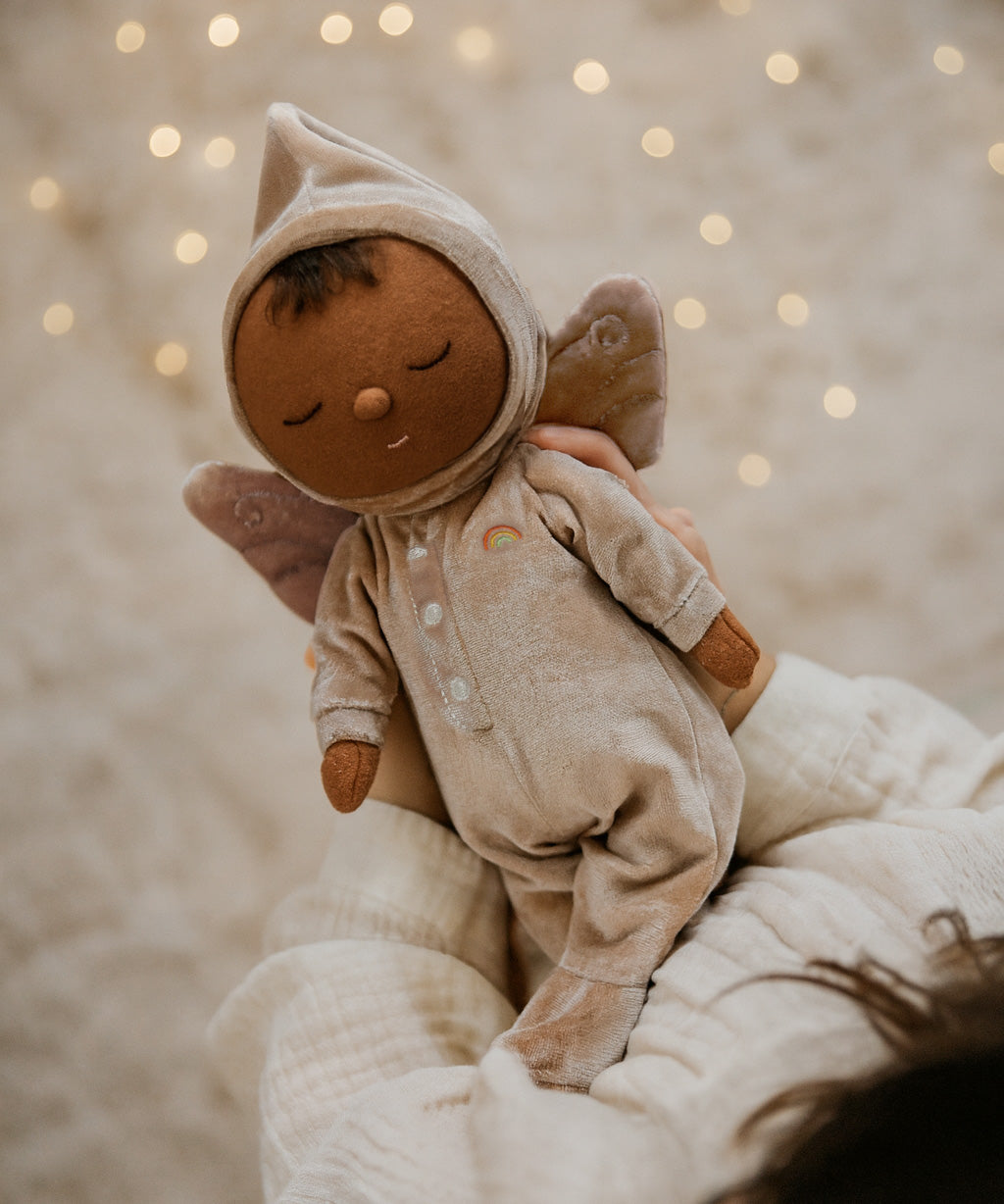 A child holding the pink Olli Ella Ada fairy dozy dinkum doll 